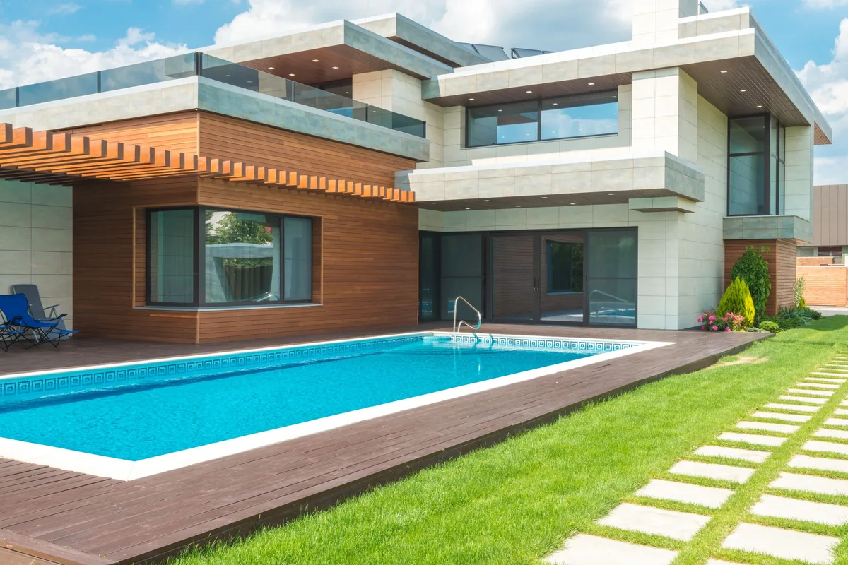 Modern home with a rectangular pool and lawn