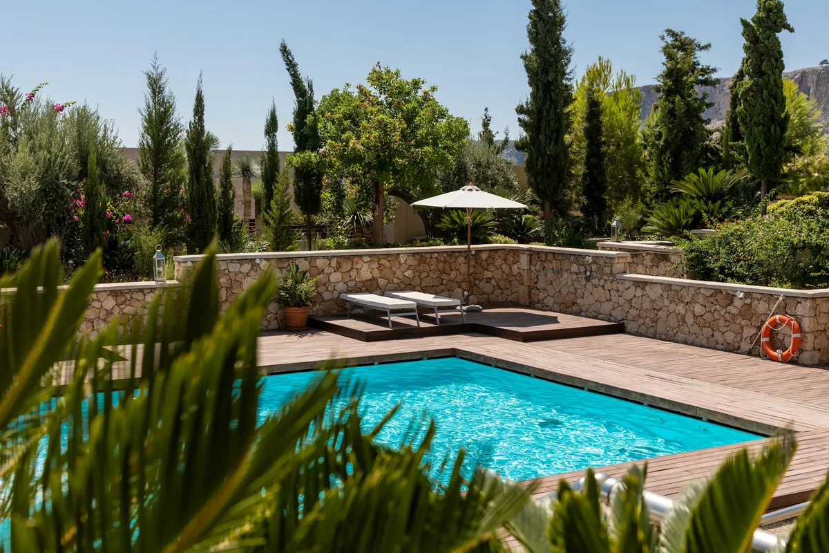 Swimming pool framed by palm trees and tropical landscaping