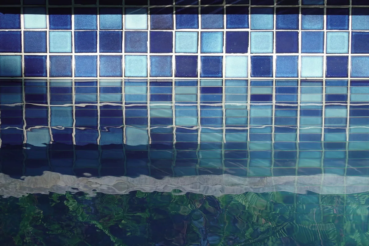 Blue glass tile waterline in a renovated pool